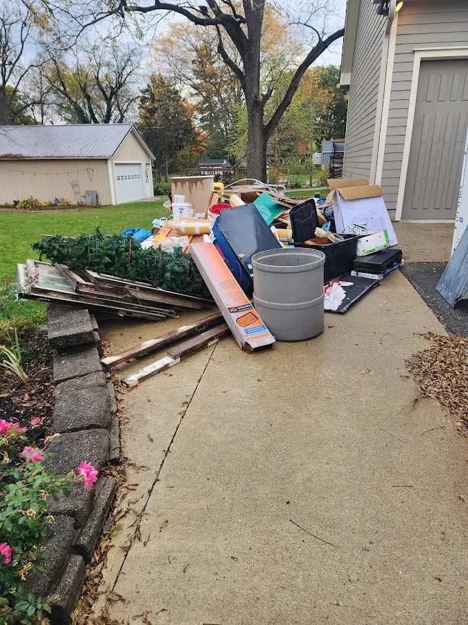 Dumpster being loaded with debris for 12 Yard Dumpster Rental in Hannibal